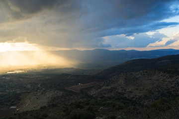 Magnificent view of the Golan Heights, the rays of the setting sun make their way through the clouds