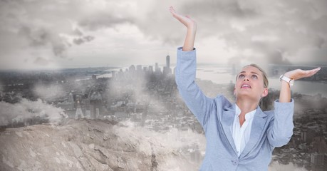 Businesswoman gesturing against landscape