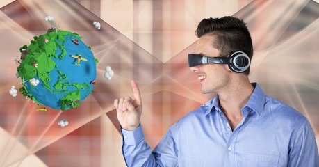 Businessman touching low poly globe while wearing VR headphones