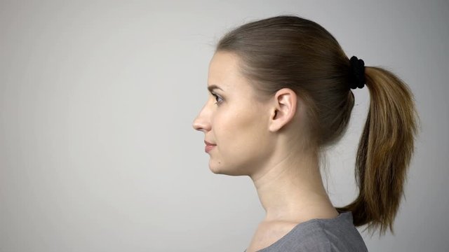 Closeup profile of confident woman looking forward isolated on gray background