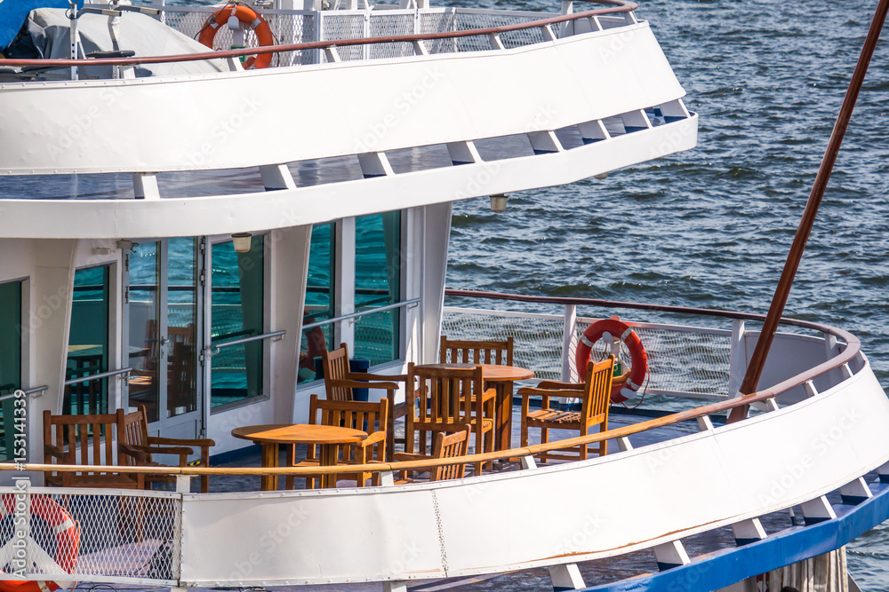 Wall mural wooden furniture tables and chairs on the open deck river cruise ship on the volga river