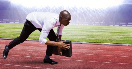 Businessman at starting point on racing track