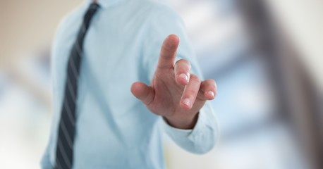 Midsection of businessman pointing screen