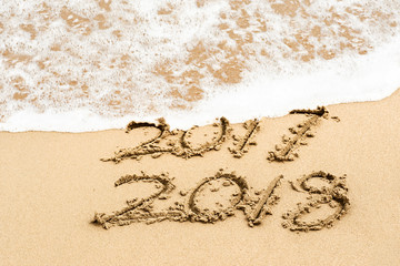 writing 2018 on the sand, happy new year
