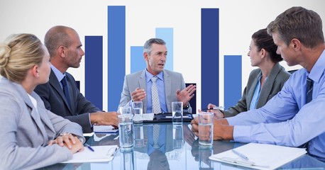 Business people discussing in meeting with graph 
