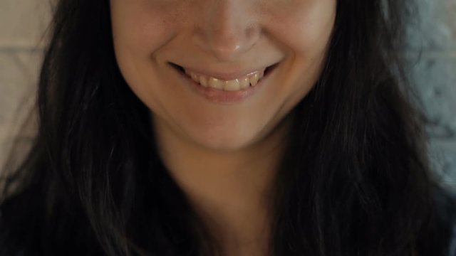 Beautiful woman smiling. Close up. Brown hair. Slow motion