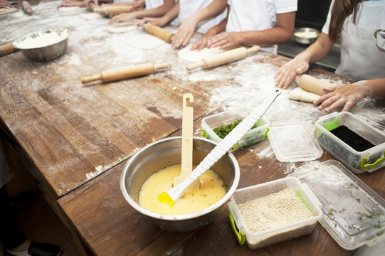 Making pastries from dough with stuffing. Children's hands close-up.