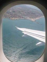 River, sea and city viewed from an airplane window