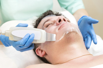 Man in the mask cosmetic procedure in spa salon 