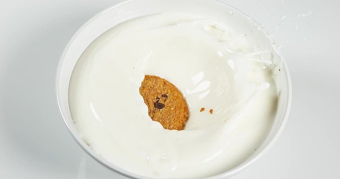 Cookie falling into a Milk Bowl, slow motion 4K