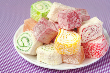 Set of assorted traditional eastern desserts. Arabian sweets on a metal dish. rahat lokum in a colorful plates. Selective focus
