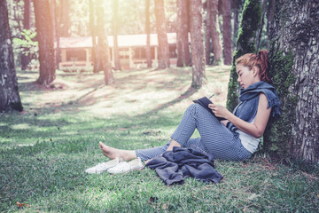 Women write notes Nature trails, mountains, forests. Writer