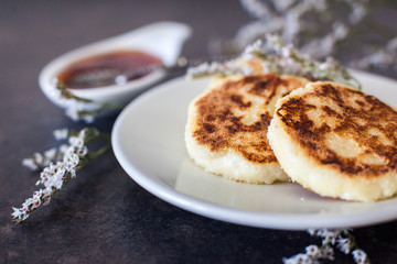 Cottage cheese pancakes with sour cream and strawberry sauce