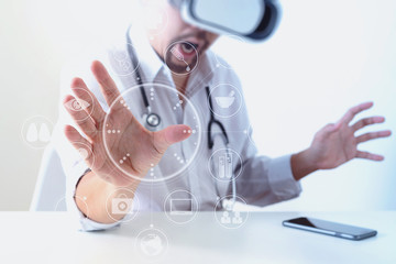 Fototapeta premium smart doctor wearing virtual reality goggles in modern office with mobile phone using with VR headset