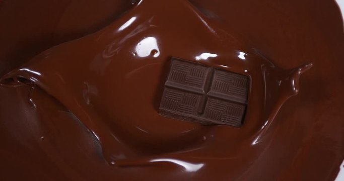 Black Chocolate tablet falling into Milk Chocolate, Slow Motion 4K
