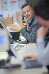 worker calling on the phone in a warehouse