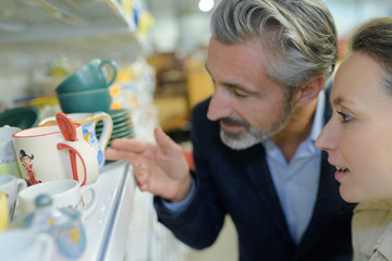 Middle aged couple looking at pottery on shelf