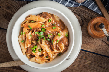 Pasta penne with pork sauce.
