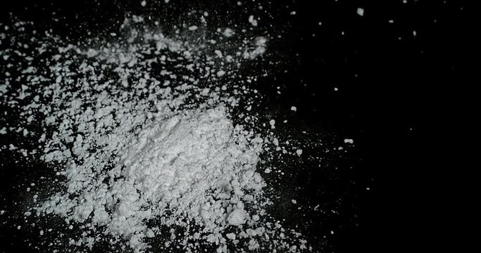 Drug, Cocaine falling against black background, Slow motion 4K