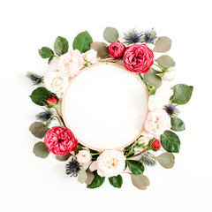 Embroidery frame with red and beige rose flower buds isolated on white background. Flat lay, top view decorated concept.