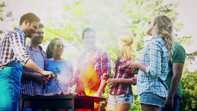 Happy friends enjoying barbecue party