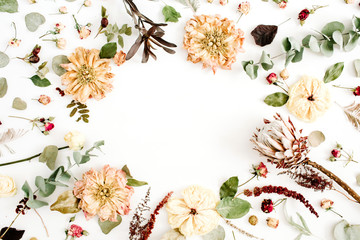 Fototapeta na wymiar Round frame wreath with dried flowers: beige peony, protea, eucalyptus branches, roses on white background. Flat lay, top view. Floral background