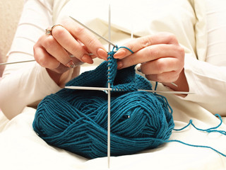 knitting. close up of woman hands knitting with knitting needles.