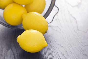 Whole Lemons Spilling Out of a Wire Basket