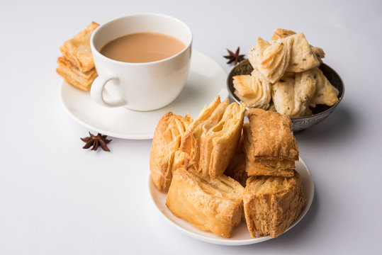 indian khari or kharee or salty Puff Pastry Snacks and tutti frutti toast, served with indian hot tea, selective focus texture