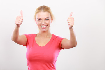 Happy woman showing thumbs up gesture