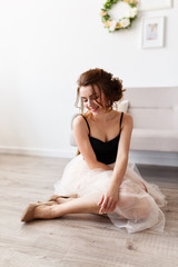 Young woman at home sitting on  the floor relaxing in her living room