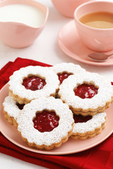Raspberry Jam Filled Linzer Torte Cookies with Tea or Coffee