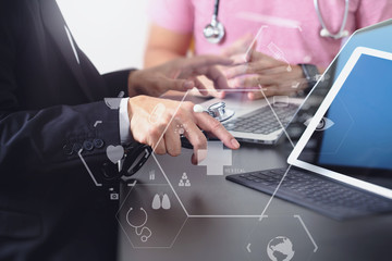 Medical co working concept,Doctor working with smart phone and digital tablet and laptop computer to meeting his team in modern office at hospital with virtual icon diagram