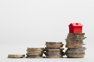 Housing cost. Red house with British currency