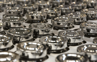 Fototapeta na wymiar Lots of shiny metal lids from jars