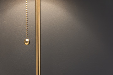 Lamp with a gold chain of the switch in the room