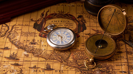 Old vintage retro compass on ancient world map. Vintage still life. Travel geography navigation...