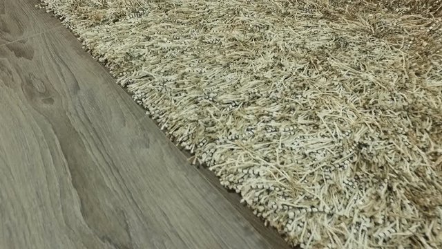 Synthetic carpet on the laminate in the home interior. Close-up