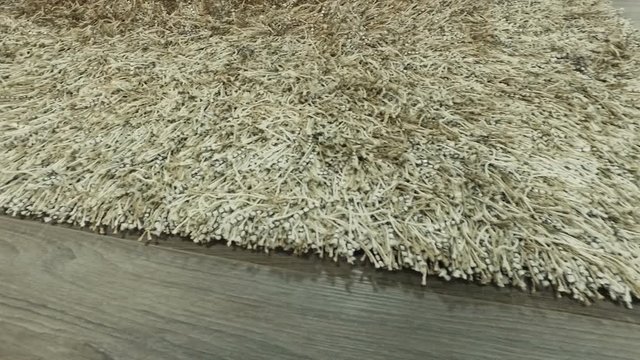 Synthetic carpet on the laminate in the home interior. Close-up