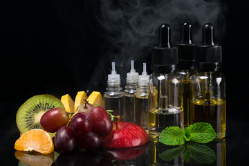 Fruit and flavors in bottles for an electronic cigarette, concept on a black background with a steam