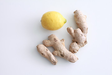 Ginger root and lemon on white