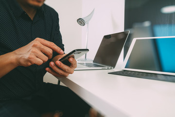businessman working with smart phone and digital tablet and laptop computer in modern office