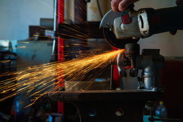 Angular grinding machine is cutting the metal and a lot of sparks