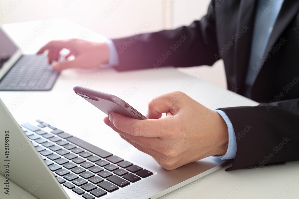 Poster Hands of businessman using mobile phone in modern office with laptop and digital tablet computer with VR icon diagram