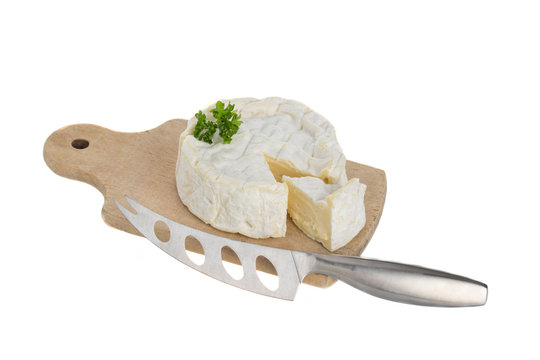 Camembert cheese cut on a wooden board
