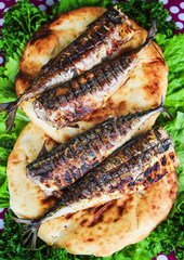 Serving fried fish with greens