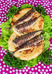 Serving fried fish with greens