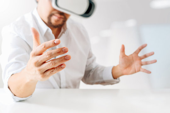 businessman wearing virtual reality goggles in modern office with Smartphone using with VR headset