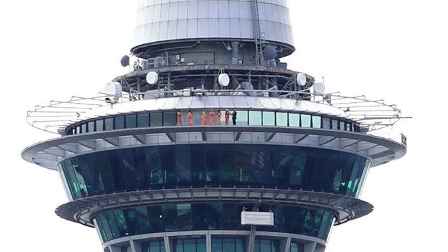 People skywalk on Auckland sky tower building
