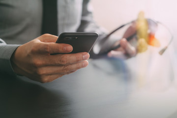 businessman using VOIP headset with mobile phone and concept communication call center on wooden desk